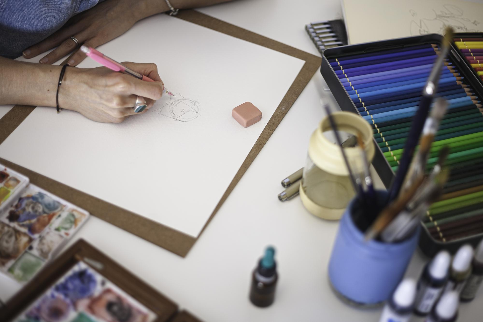 Studio workspace with embroidered samples and digital patterns